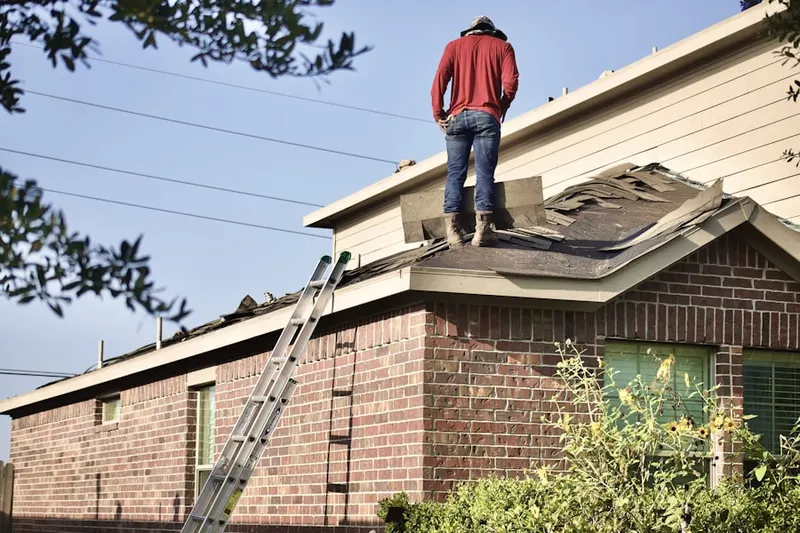 Professional roofer working on a residential roof in Russell Plantation